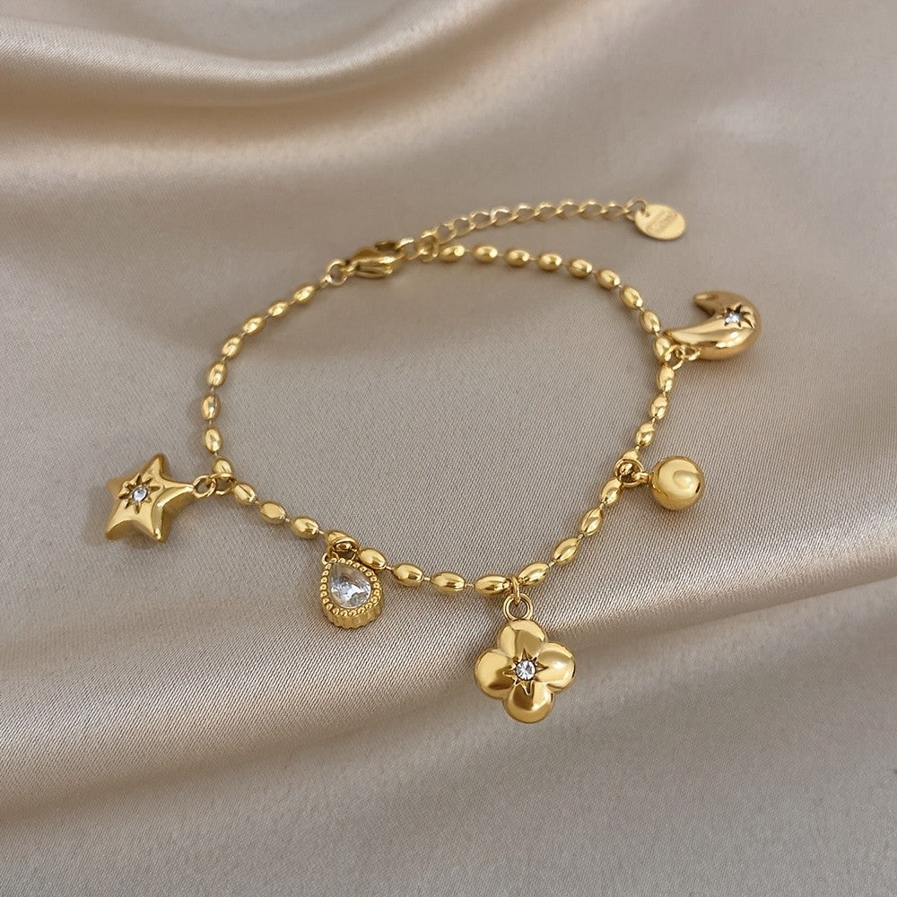 18k Charm Bracelet with Star and Flower Pendants