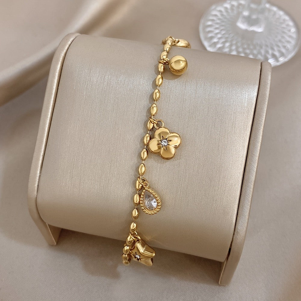 18k Charm Bracelet with Star and Flower Pendants