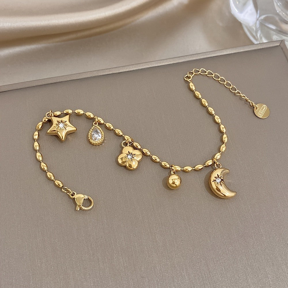 18k Charm Bracelet with Star and Flower Pendants